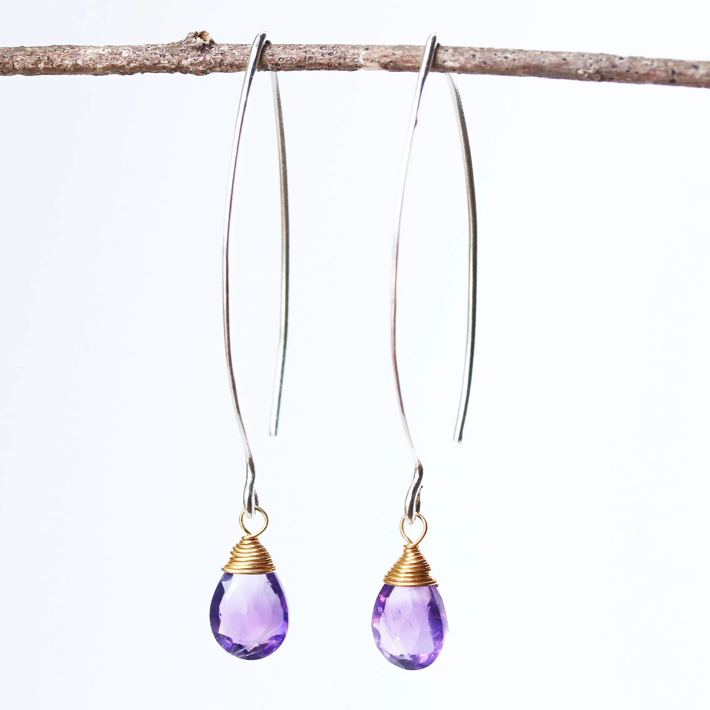 Amethyst February birthstone gemstone drop earrings with long sterling silver dangle and 24k gold plated wrap wire on the faceted gemstone