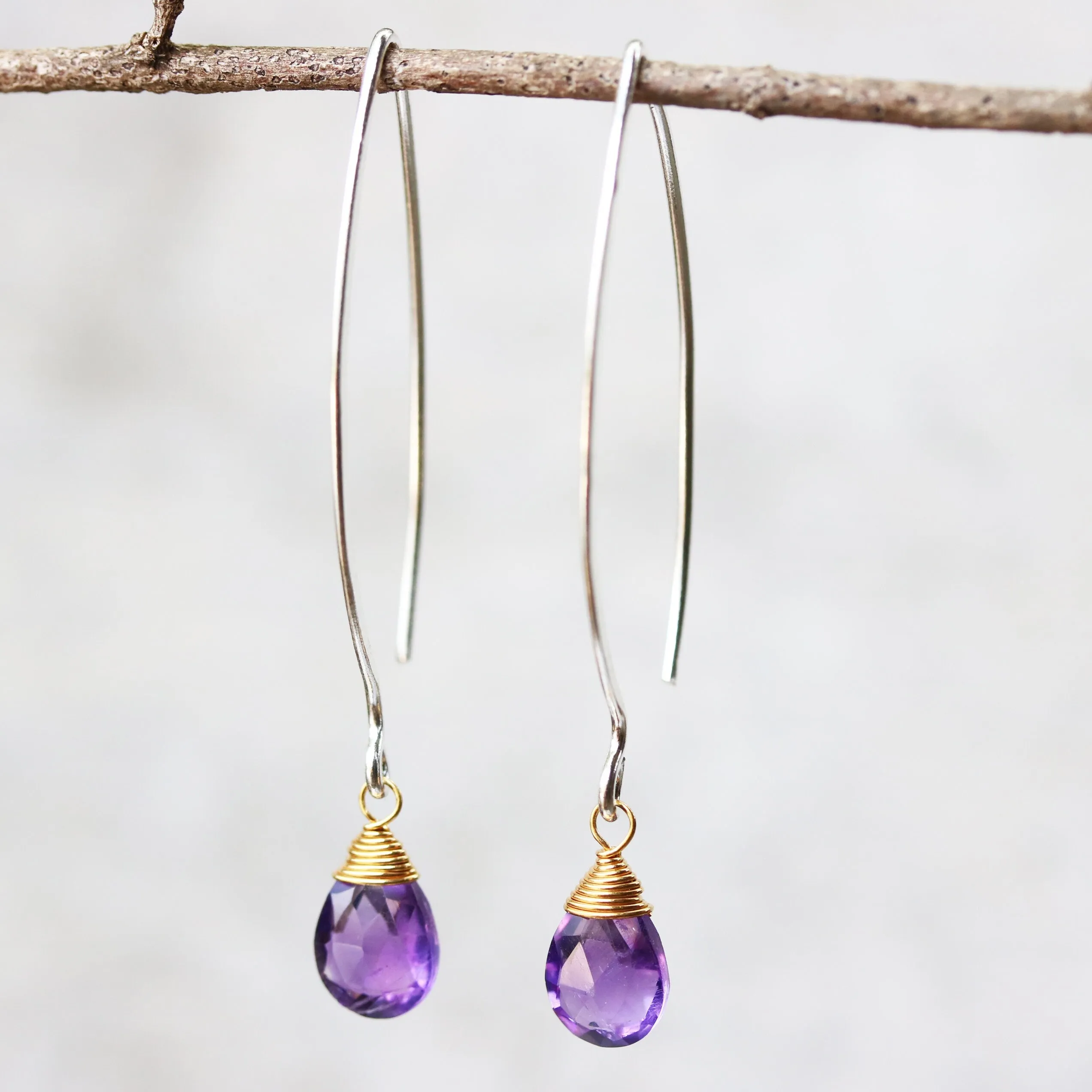 Amethyst February birthstone gemstone drop earrings with long sterling silver dangle and 24k gold plated wrap wire on the faceted gemstone