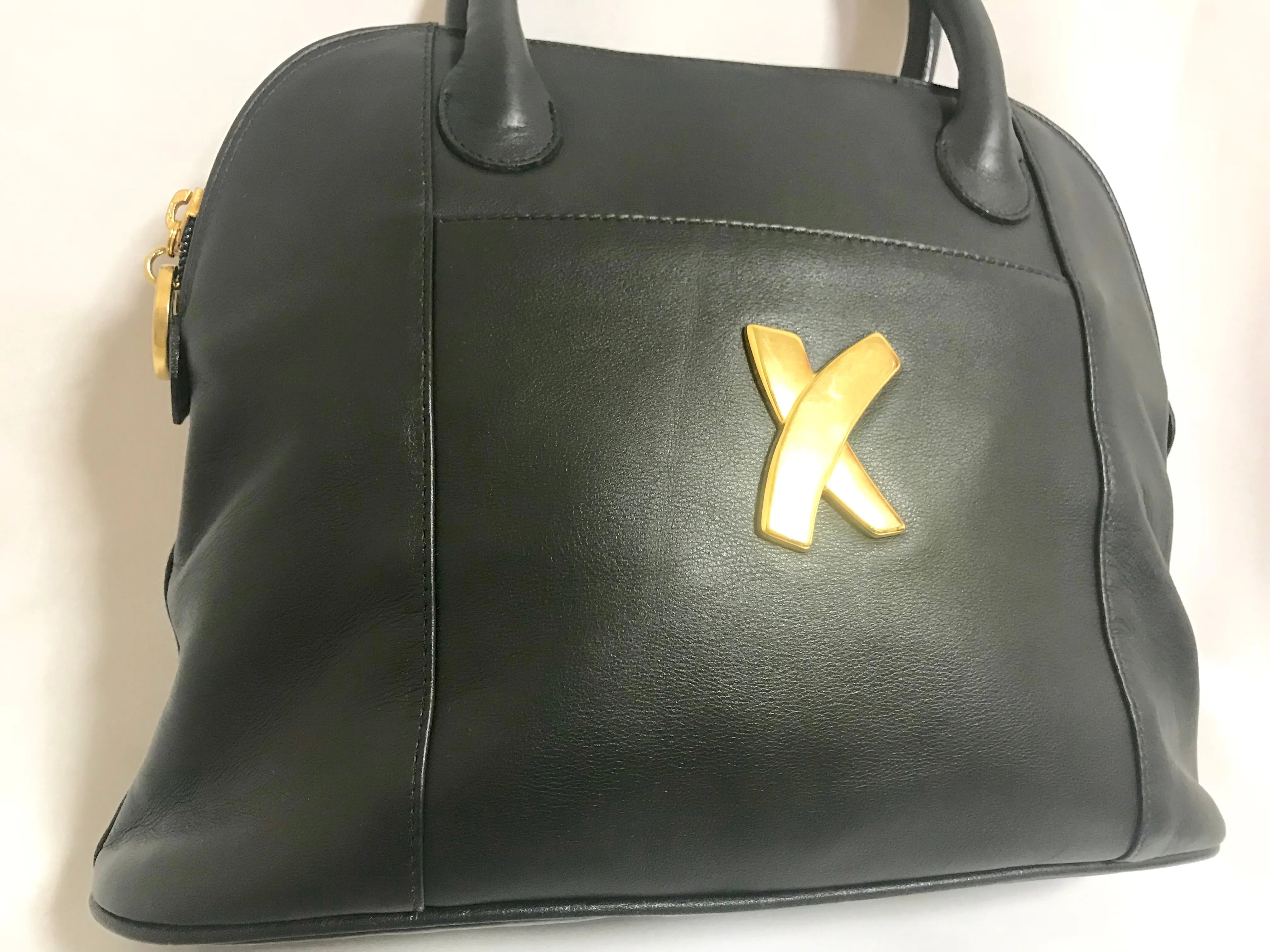 Vintage Paloma Picasso black leather bolide bag style handbag with iconic golden logo motif. Classic shape bag.