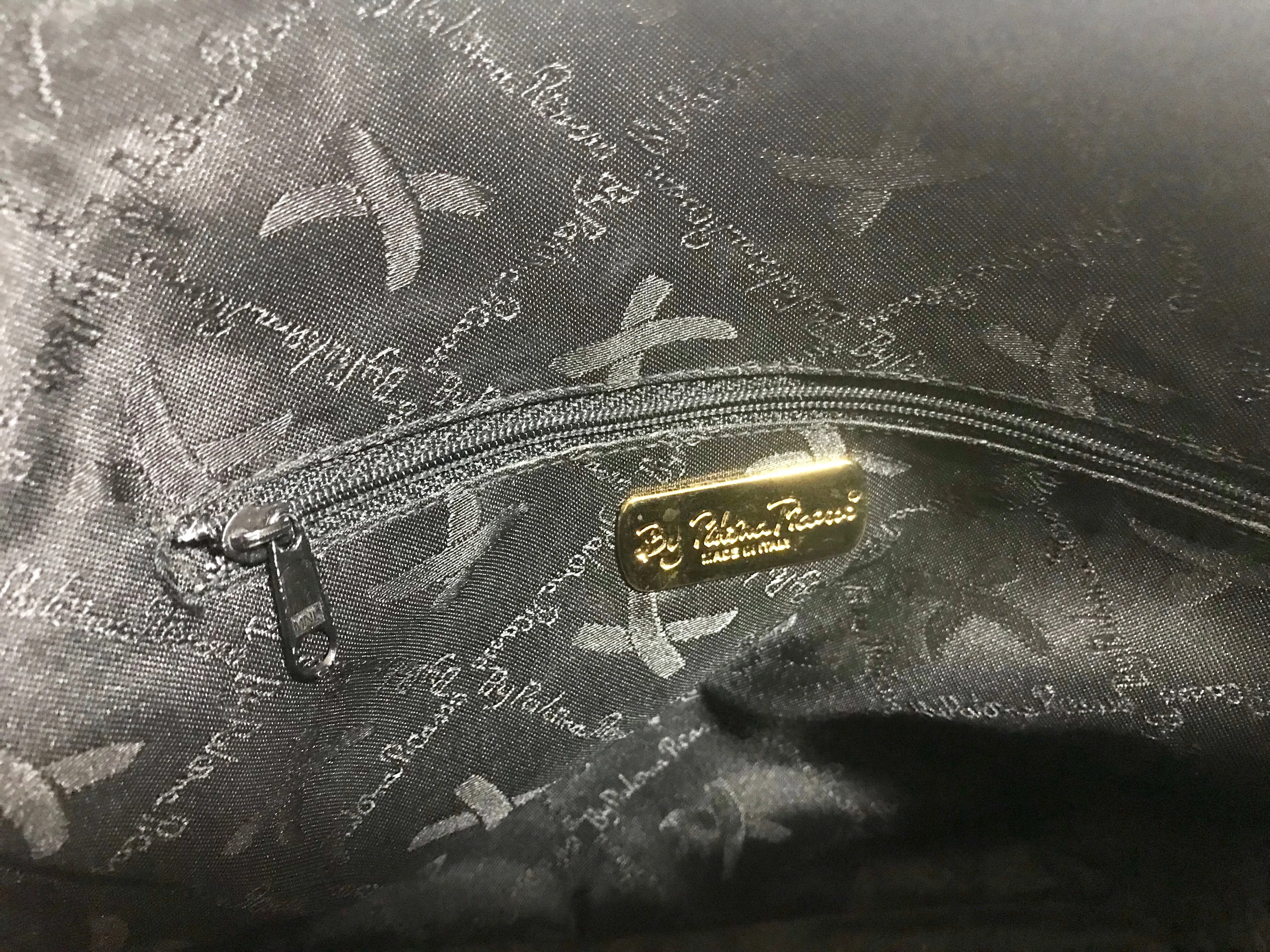 Vintage Paloma Picasso black leather bolide bag style handbag with iconic golden logo motif. Classic shape bag.
