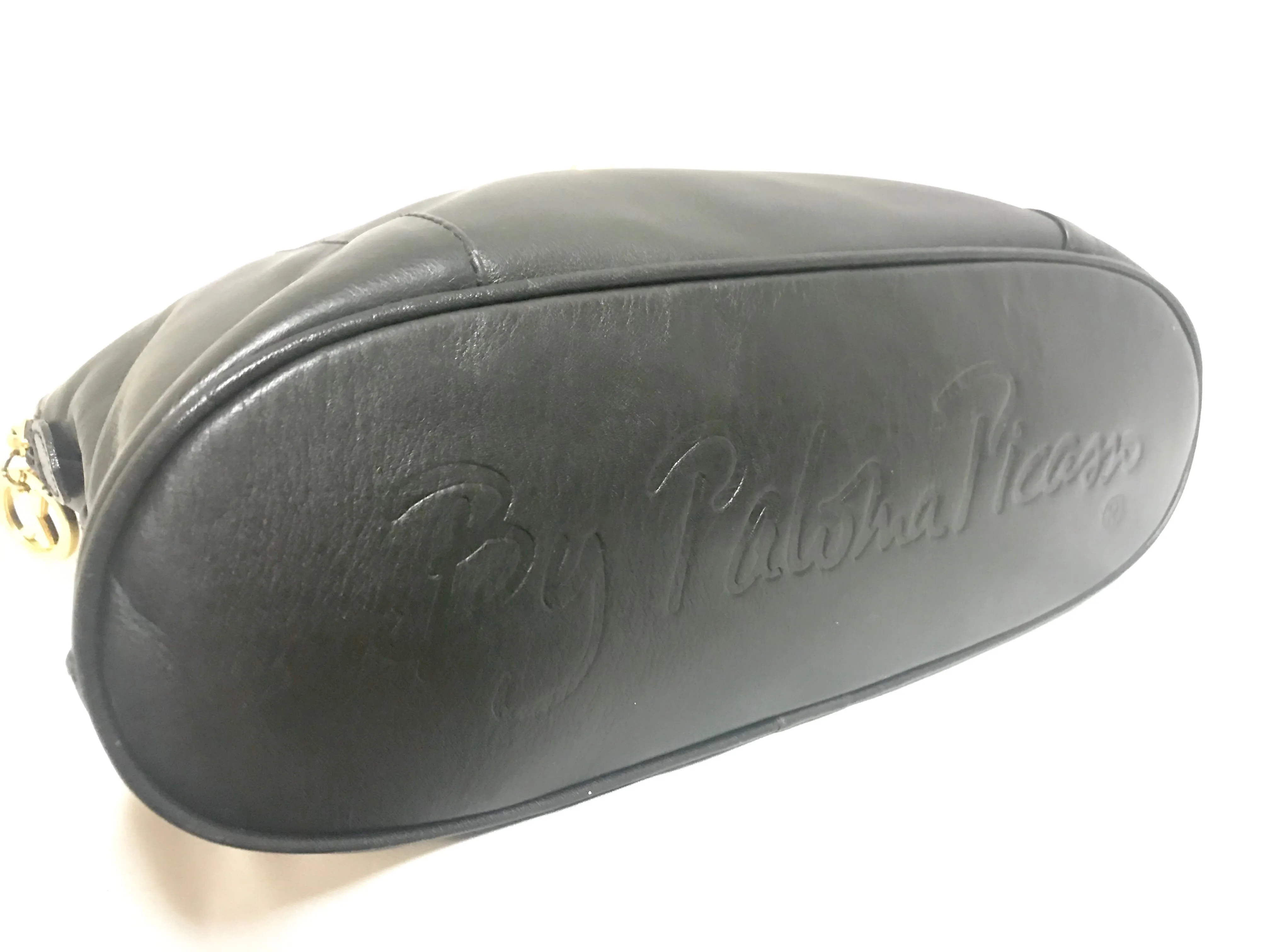 Vintage Paloma Picasso black leather bolide bag style handbag with iconic golden logo motif. Classic shape bag.