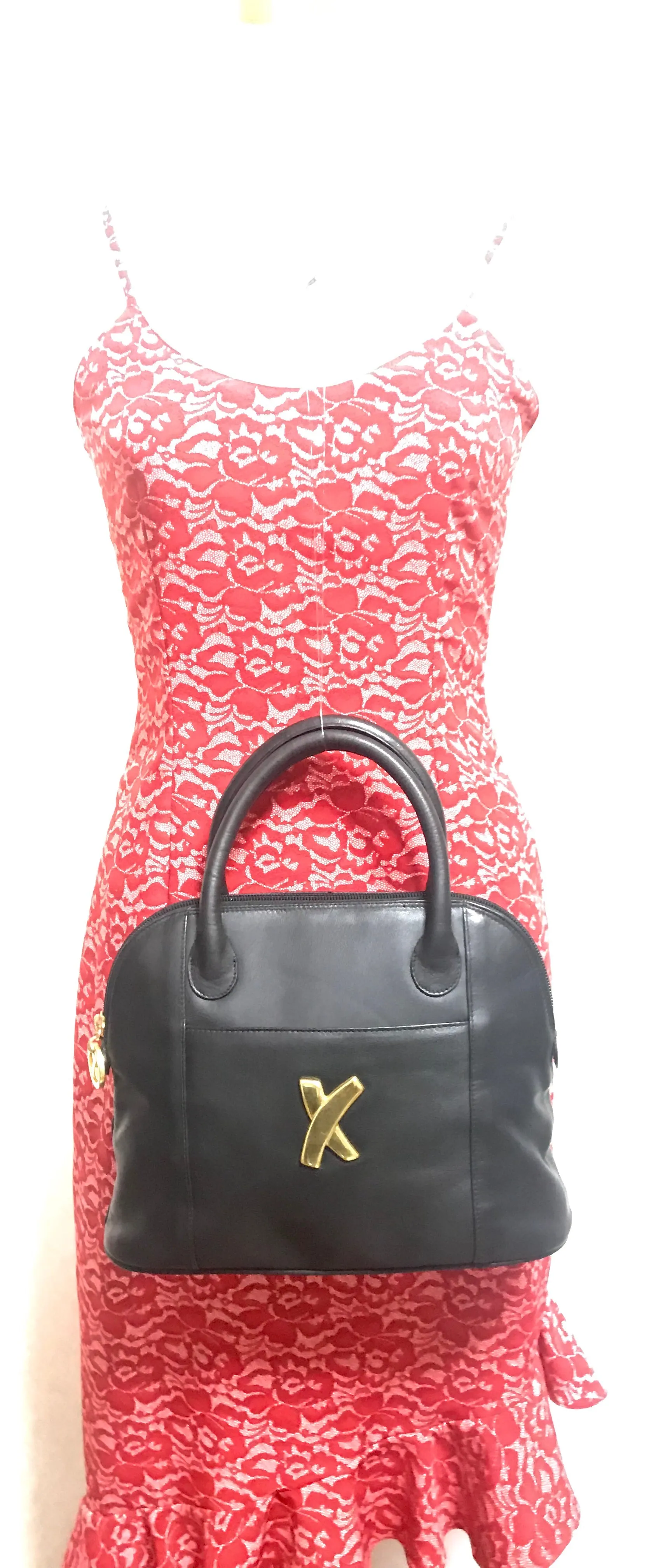 Vintage Paloma Picasso black leather bolide bag style handbag with iconic golden logo motif. Classic shape bag.